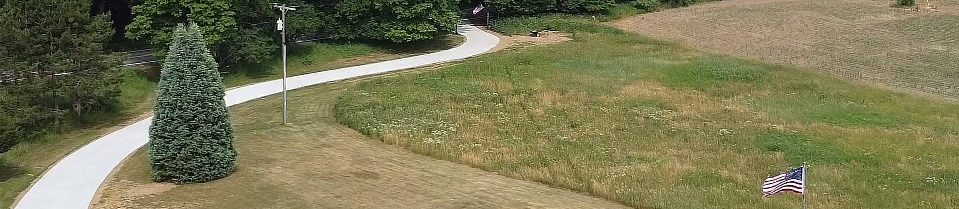 A long winding concrete driveway.